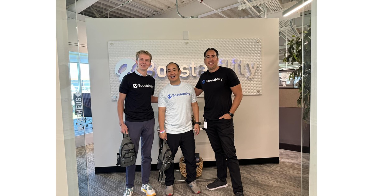 Jack Wendt and Dennis Yu standing in front of the Boostability sign during an office visit
